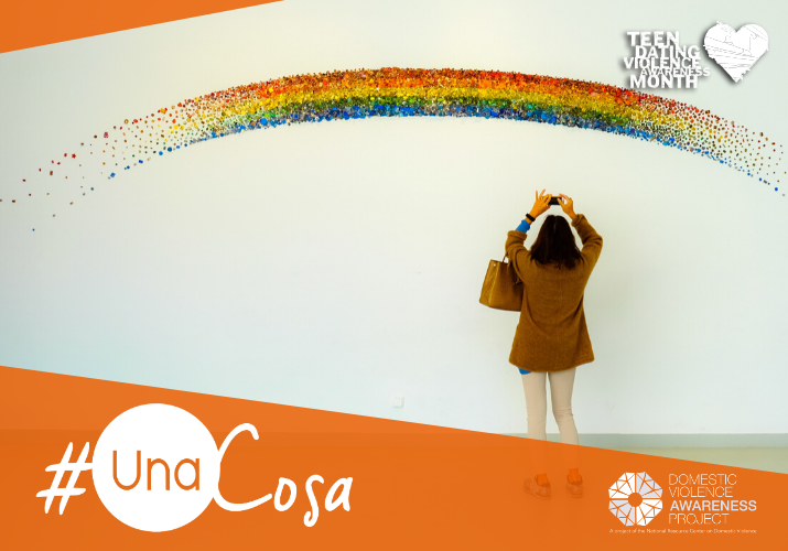 woman taking a photo of a rainbow art installation  #unaCosa